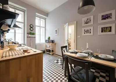 a kitchen with a table and a dining room at Wishlist Old Prague Residences - New Town in Prague