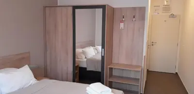 a bedroom with a mirror with a bed in it at HOTEL ARÉNA in Prague
