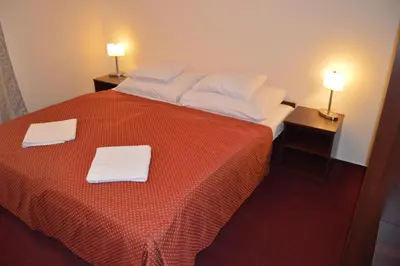 a hotel room with a bed with two towels on it at HOTEL ARÉNA in Prague