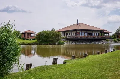 a house on the side of a river with a house at Rooms & Restaurace Na Jitrách in Semice