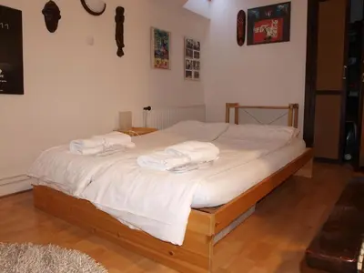a bed with white sheets and towels on it at Attic Apartment City Center in Prague