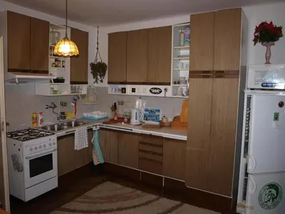 a kitchen with wooden cabinets and a white refrigerator at Attic Apartment City Center in Prague