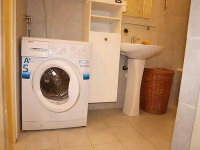 a washing machine in a bathroom with a sink at Attic Apartment City Center in Prague
