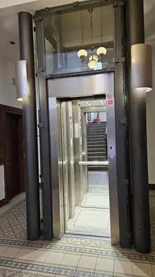 a hallway with an elevator in a building at Maiselova House in Prague