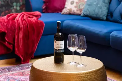 a bottle of wine and two wine glasses on a table at Maiselova House in Prague