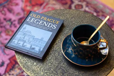 a book sitting on a table next to a cup of coffee at Maiselova House in Prague