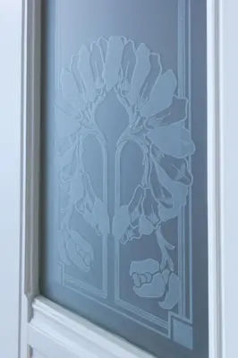 a blue glass door with a flower pattern on it at Maiselova House in Prague