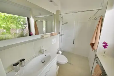 a bathroom with a sink and a toilet and a mirror at A. V. Pension Praha in Prague