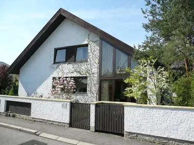 a white house with a black fence at A. V. Pension Praha in Prague