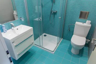 a bathroom with a toilet and a shower and a sink at Apartments Embassy by LH in Prague