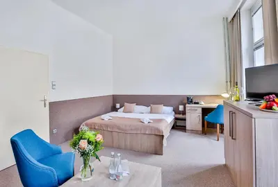 a hotel room with a bed and a television at Apartments Embassy by LH in Prague