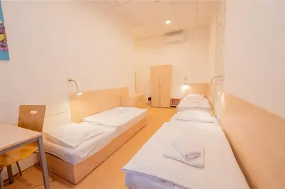 a hospital room with two beds and a table at Drunken Monkey Hostel in Prague