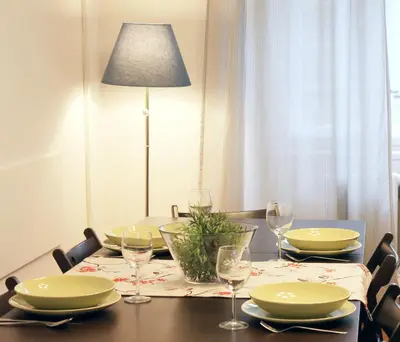 a dining room table with plates and wine glasses at Modern apartment Michalska 6 in Prague