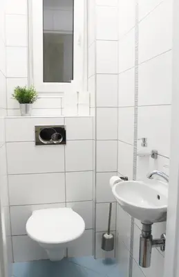 a white bathroom with a toilet and a sink at Modern apartment Michalska 6 in Prague