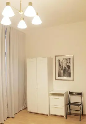 a room with a desk and a cabinet and lights at Modern apartment Michalska 6 in Prague