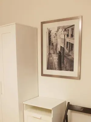 a mirror on a wall next to a white cabinet at Modern apartment Michalska 6 in Prague