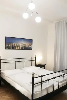 a bedroom with a bed and a tv on the wall at Modern apartment Michalska 6 in Prague
