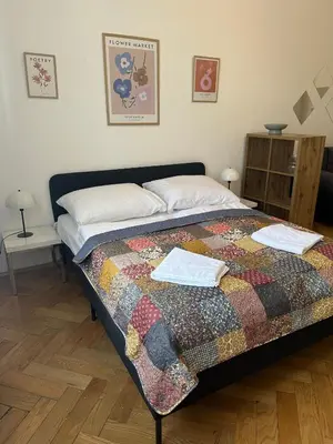 a bedroom with a bed with a quilt on it at Apartment Skorepka 4 in Prague
