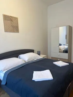 a bedroom with a bed with two towels on it at Apartment Skorepka 4 in Prague