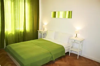 a bedroom with a bed with a green blanket at Apartment Lea in Prague
