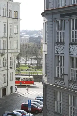 a red bus parked in a parking lot next to buildings at Apartment Lea in Prague