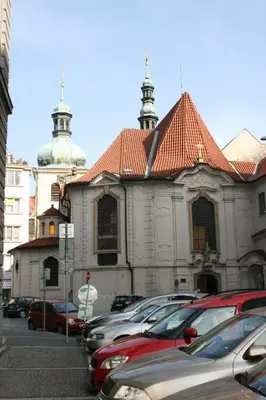 a church with cars parked in a parking lot at Apartment Lea in Prague