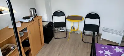 a room with two chairs and a desk in a bedroom at Prague Retro Challenge and Garden in Prague