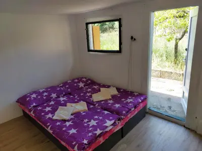 a small bed in a room with a window at Prague Retro Challenge and Garden in Prague