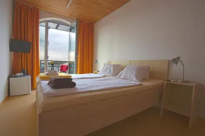a bedroom with a large bed with a window at Labe Aréna Račice in Štětí