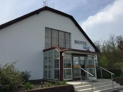 a white building with a hotel sign on it at Labe Aréna Račice in Štětí