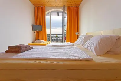 a bedroom with a large bed with an open window at Labe Aréna Račice in Štětí