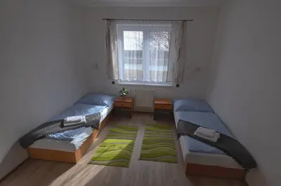 a room with two beds and a window at Labe Aréna Račice in Štětí