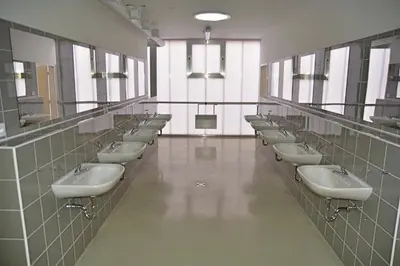 a bathroom with a row of sinks and mirrors at Labe Aréna Račice in Štětí