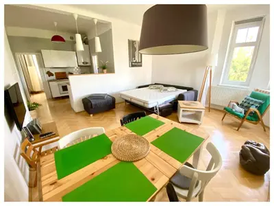 a kitchen and living room with a table and chairs at Central-Modern-Apartment in Prague