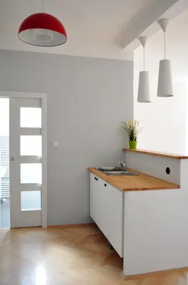 a kitchen with a sink and a red lamp at Central-Modern-Apartment in Prague