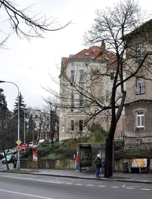 a person standing on a sidewalk in front of a building at Central-Modern-Apartment in Prague