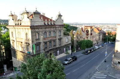 an old building on a city street with cars parked at Central-Modern-Apartment in Prague