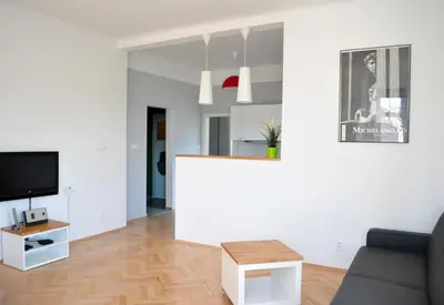 a living room with a couch and a tv at Central-Modern-Apartment in Prague