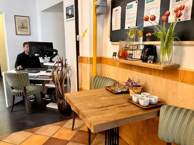 a man sitting at a desk in front of a computer at Pension SKLEP in Prague