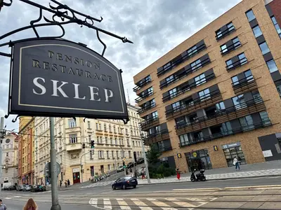 a sign that reads permission maintenance skipeper on a city street at Pension SKLEP in Prague