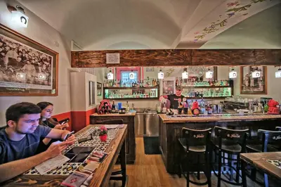 a group of people sitting at a bar at Apartment Americká 8 in Prague