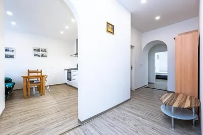 a room with white walls and a table and chairs at Apartment Americká 8 in Prague