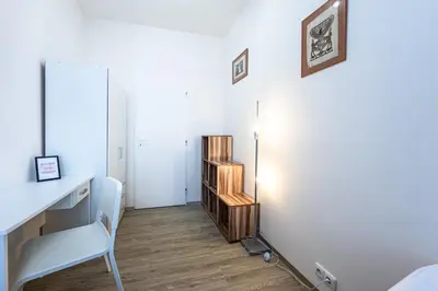 a bedroom with a white desk and a chair at Apartment Americká 8 in Prague