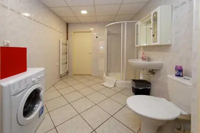 a bathroom with a washing machine and a sink at Apartment Americká 8 in Prague