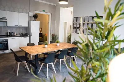 a kitchen and dining room with a wooden table and chairs at Onefam Old Town in Prague