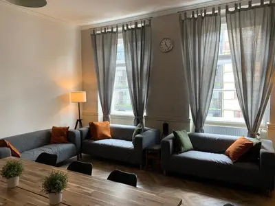 a living room with two couches and a table at Onefam Old Town in Prague