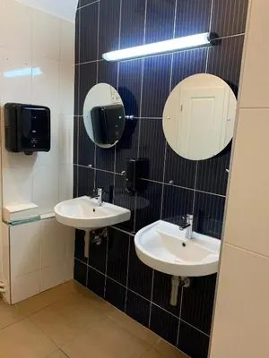 a bathroom with two sinks and mirrors on the wall at Onefam Old Town in Prague
