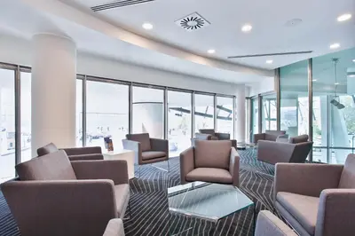 a waiting room with chairs and tables and windows at Dancing House - Tančící dům hotel in Prague