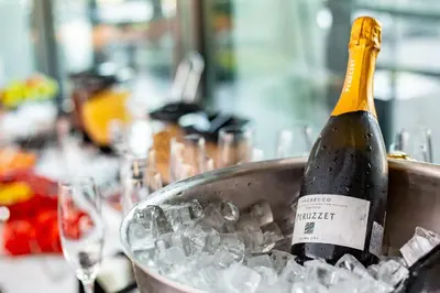 a bottle of champagne in a bucket of ice at Dancing House - Tančící dům hotel in Prague