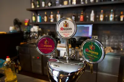 a bar with three different types of alcohol bottles at Brix Hostel in Prague